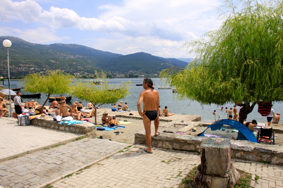 Concrete docks and gravel areas become makeshift beaches for sunbathing and swimming